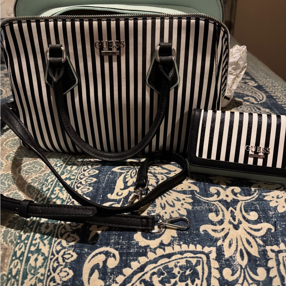NEVER USED! Still has original packing inside and tags. Matching wallet too.